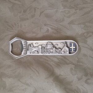 Metal (pewter?) Quebec themed bottle opener with magnet on back for fridge